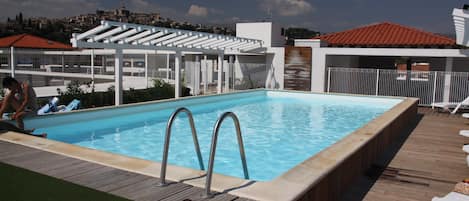 Lounge around the on-site outdoor pool.