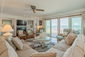 Lovely Oceanfront living room w/ Fireplace, Balcony, and Comfortable living room Furniture.