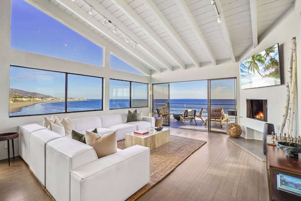 Relax by the fireplace, the perfect spot for unwinding after a day by the sea.