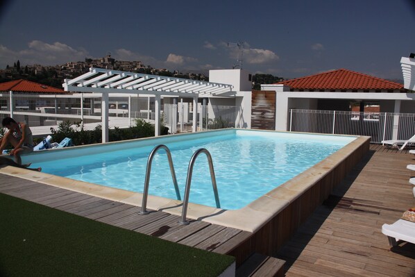 Lounge around the on-site outdoor pool.