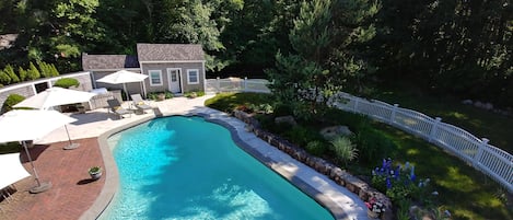 View of the Pool House and proximity to the pool and surround