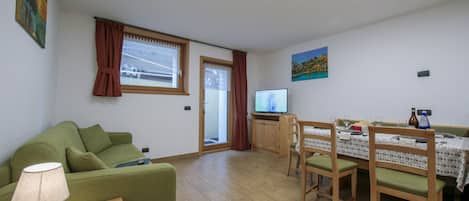 Living area with tv and open plan kitchen