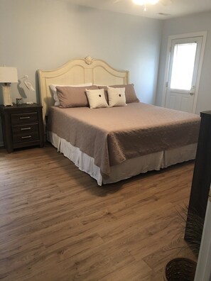 King size bedroom with en suite bathroom and outdoor patio access