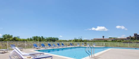 Lounge by the pool in the sunshine.