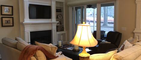 Open floor plan with new flat screen television and gas fireplace.