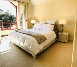 Main bedroom opening up to balcony over looking cortyard and BBQ area