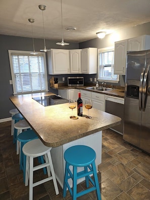 Relax with a glass of wine or eat breakfast in this spacious kitchen with alot of counter space.