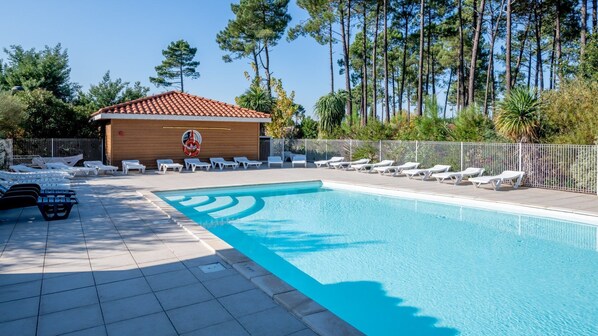 Lounge by the pool in the sunshine.