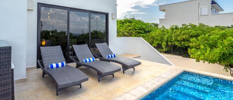 Front patio with infinity pool has plenty of seating.