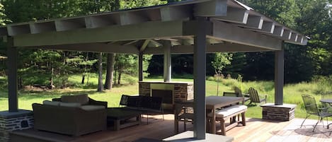 Weather-resistant outdoor room, with fireplace, ceiling fan and lighting