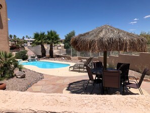 Pool and spa area with small waterfall, 2 lounge chairs & palapa seating for 6.