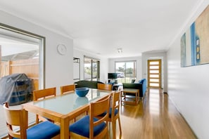 Open plan indoor dining space offers natural lighting into the space, creating a cozy ambience