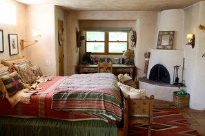 bedroom with desk and fireplace