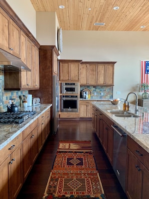 Custom cabinetry with soft close drawers and cabinets. Generous prep area.