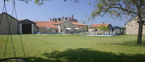 View across the communal gardens to the 3 gites and swimming pool