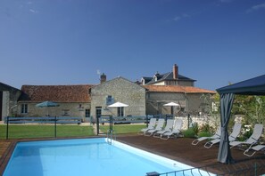 Enclosed swimming pool with 3 gites beyond