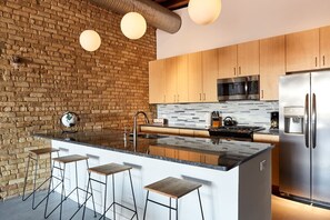 Gourmet kitchen with gas range and granite countertops