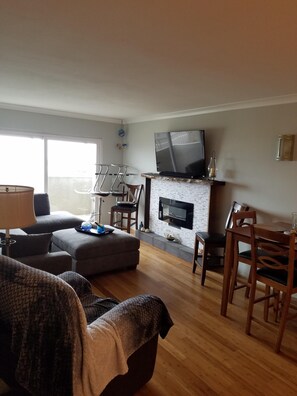 Relax in the living area with fireplace and TV