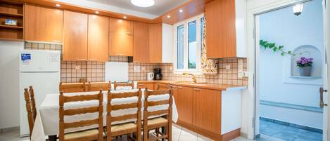 Open plan kitchen fully equipped with table seating 7 or 9 persons.