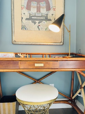 Small desk offers work space within primary bedroom