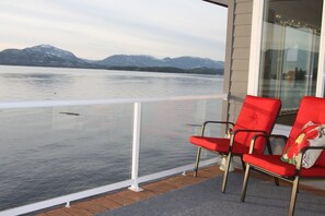 The covered deck has good seating. You'll be as close to the ocean as possible.