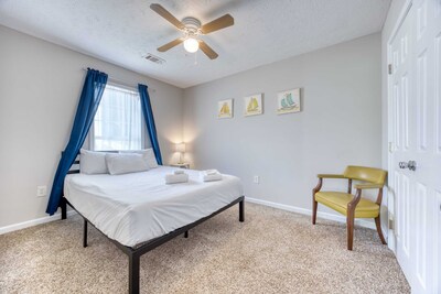Comfortable Bedroom with Soft Pillows and chair