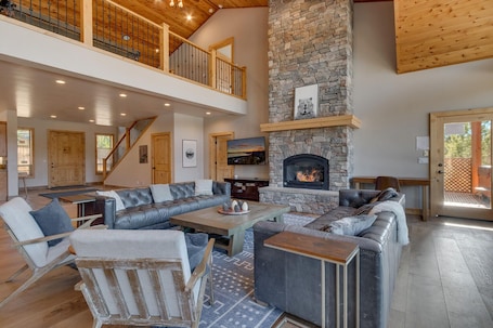 Spacious living area with contemporary furniture, flat screen tv, and fireplace