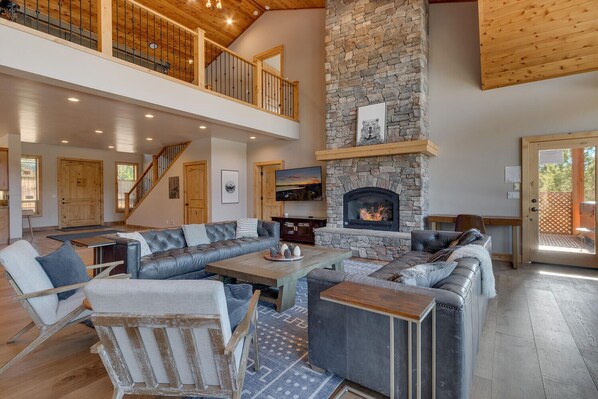 Spacious living area with contemporary furniture, flat screen tv, and fireplace