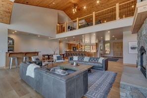 Spacious living area with contemporary furniture, flat screen tv, and fireplace