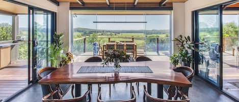 Dining room opening onto the timber deck and amazing rural view over the valley.