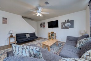 Comfy living space with a sofa, a futon, and a SmartTV