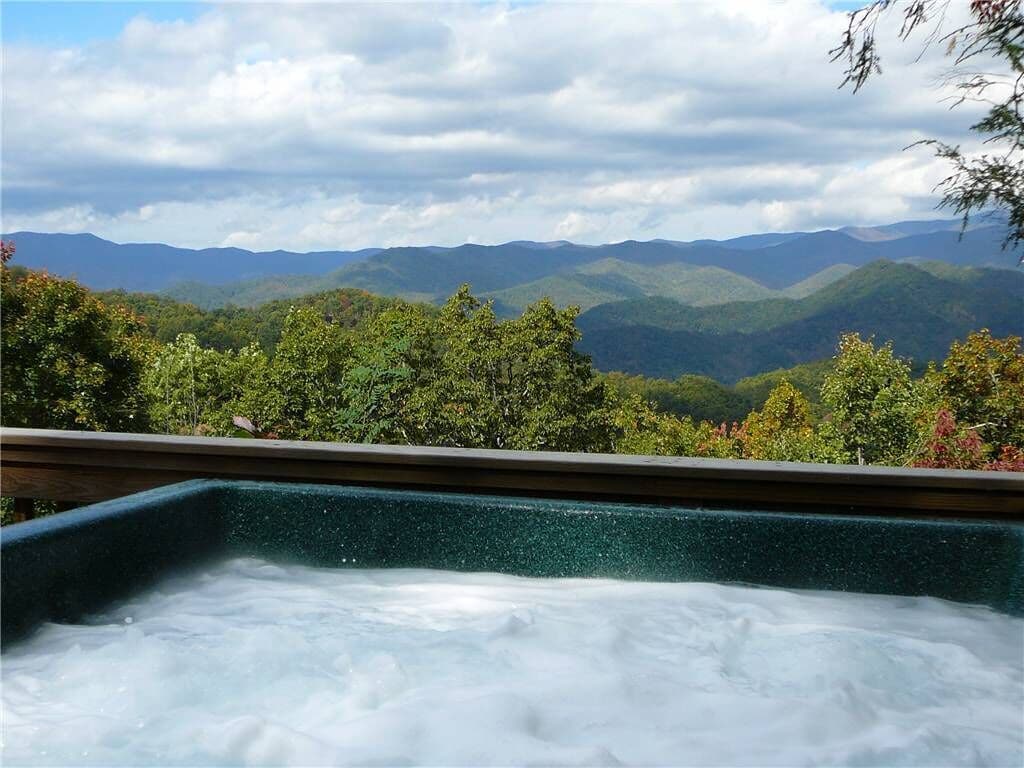 View of green mountains from a hot tub.