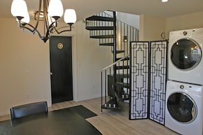 Black entry door to Shroom Suite, staircase up to Perch Suite & Summit Suite