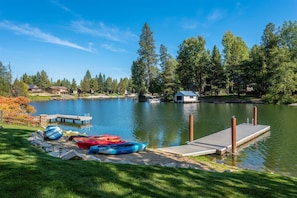 Sandy beach with kayaks and paddle boards all provided for your use.