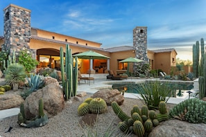 Elegantly designed backyard captures the natural desert and also a lush oasis with grass and pool and spa - all with the mountains just beyond the property line which give you stunning views all around!