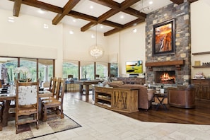The great room is the heart of the home, combining living, dining, games, billiards, and meal prep in the gourmet kitchen. Huge flat panel TV with Apple TV. Gas fireplace adds warmth and comfort to the plush seating area.