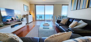 Open plan living room and dining area with ocean views