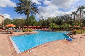 Giant resort pool with Cabanas, kid pool, and a bar and restaurant