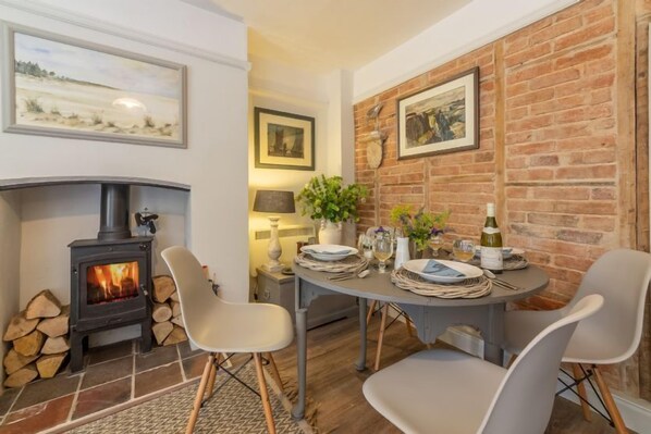 Piper Cottage, Holme-next-the-Sea:Dining area with wood burning stove