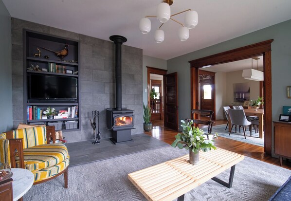 Living Room with wood burning stove, flat screen tv and record player.
