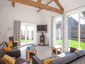 Welcoming living space with wood burner | The Cartshed, Slindon, near Eccleshall