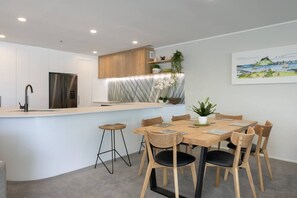 Open plan living with dining area, breakfast bar and modern kitchen.