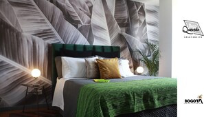 Cozy queen bed with luxe linens, cool design, and serene natural atmosphere