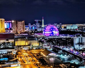 Night view from balcony showing MSG Sphere.