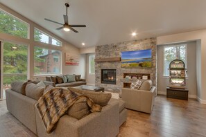 Living area with contemporary furniture, flat screen tv, fireplace, and slot machine