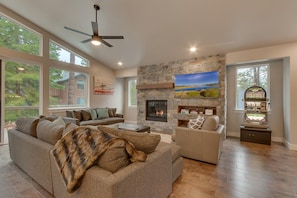 Living area with contemporary furniture, flat screen tv, fireplace, and slot machine