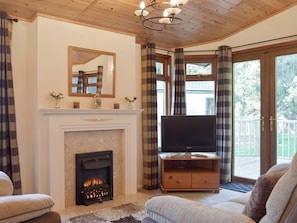 Inviting holiday lodge with French doors to terrace | Colman Brook Lodge, Corton, near Lowestoft
