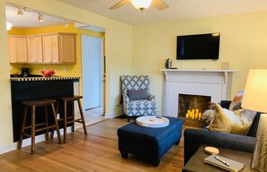 Open concept living room and kitchen with eat-in bar designed by local artist. 