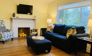 Cozy and luxurious living room with fine furnishings and roku television. 