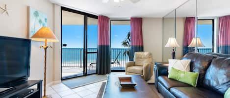 Spacious Living Room with Queen Size Sleeper Sofa offers Comfortable Seating, Beachfront Views and Balcony Access